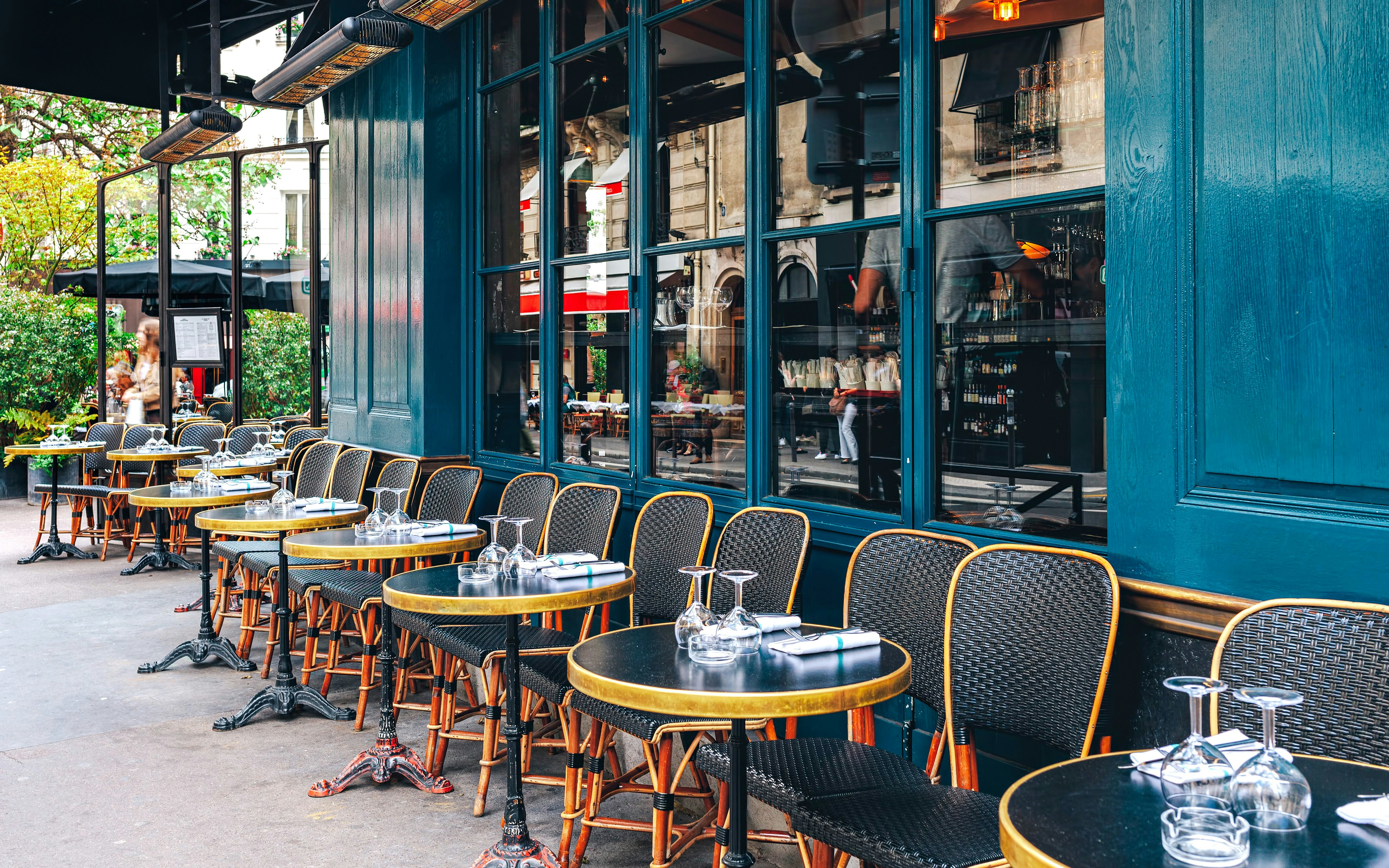Outdoor seating at La Coupole, Paris, with tables set for dining.