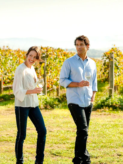 Couple enjoying wine in Yarra Valley vineyard.