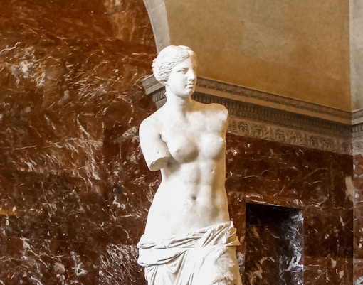 Close-up view of the Venus de Milo statue in the Louvre Museum, Paris, a highlight of the museum tour