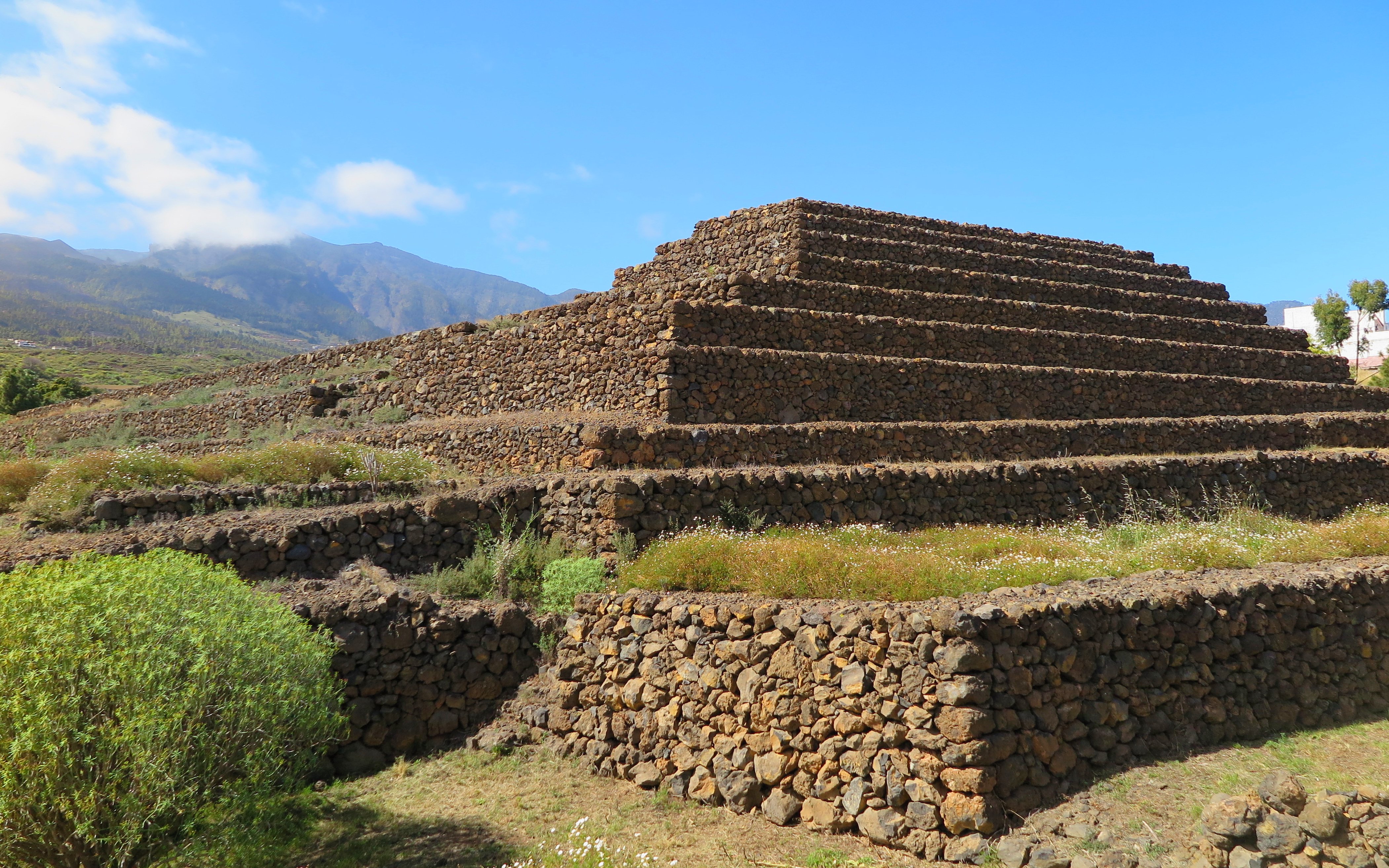 Pyramids of Güímar in Tenerife with mountainous backdrop.