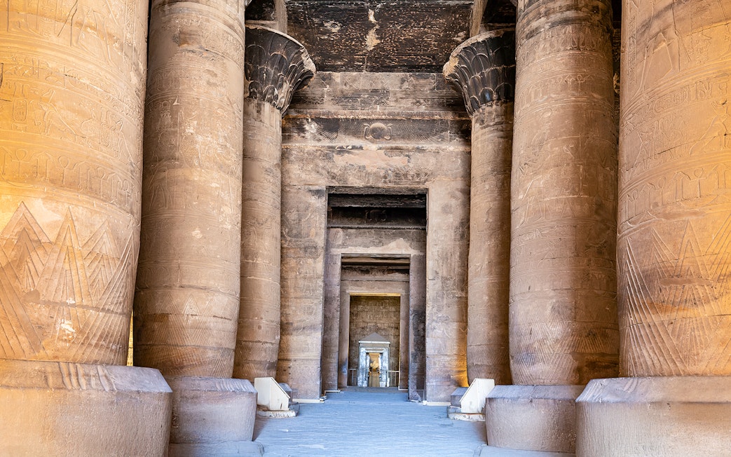 Tall pillars with relief carvings at Temple of Horus, Edfu, Egypt.