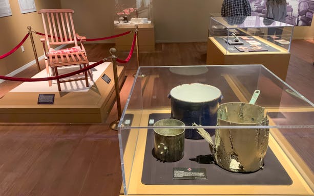 Artifacts from Titanic: The Artifact Exhibition, including a deck chair and cooking pots.