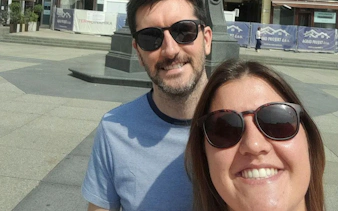 Selfie of two people in Zagreb city square during a sunny day.