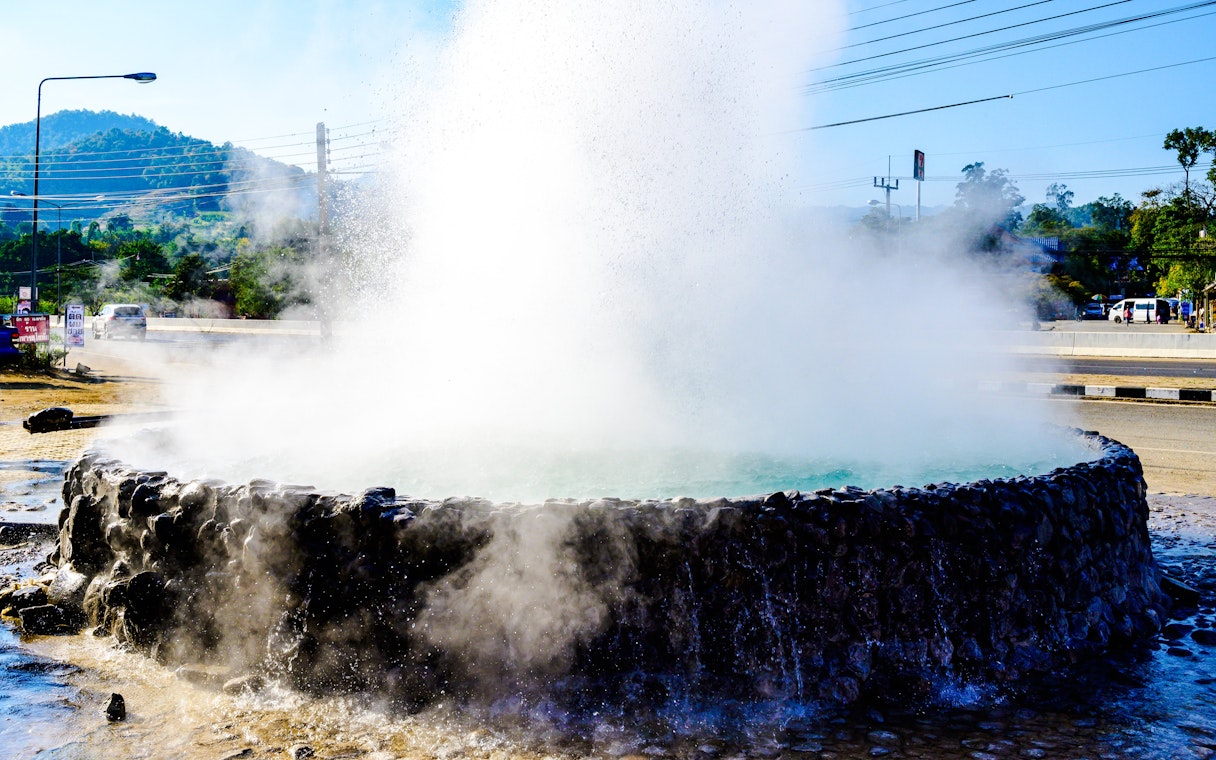 Mae Khachan Hot Spring geyser in Chiang Rai Province, Thailand, releasing steam.