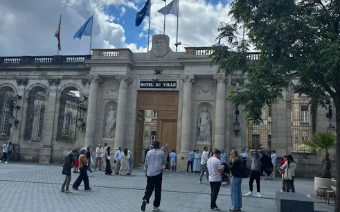 Hôtel de Ville in Bordeaux with people gathered for a self-guided city exploration game.