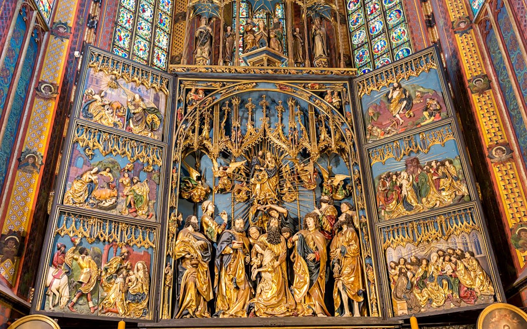 St. Mary's Basilica altar with intricate religious carvings, Krakow Old Town tour.