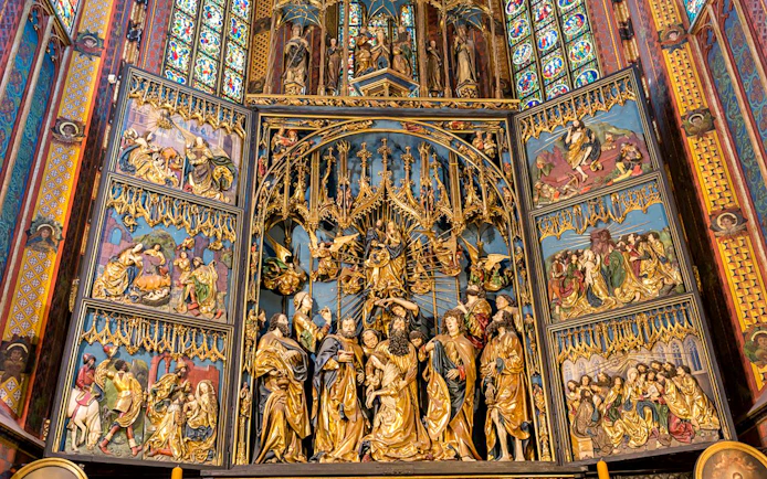 St. Mary's Basilica altar with intricate religious carvings, Krakow Old Town tour.