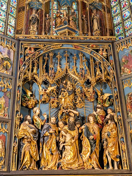 St. Mary's Basilica altar with intricate religious carvings, Krakow Old Town tour.