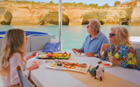 Brunch and drinks on a boat with view of Benagil Caves, Algarve coast.