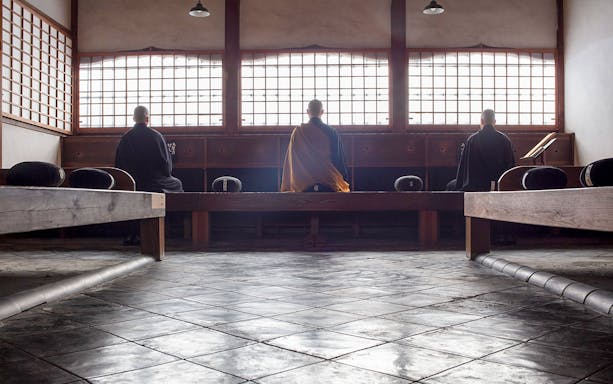 Kosho-ji Temple interior with people practicing Zazen meditation in Kyoto, Japan.