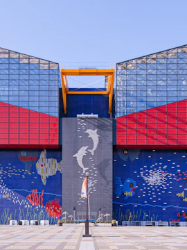 Exterior of Osaka Aquarium Kaiyukan with colorful marine-themed mosaic.
