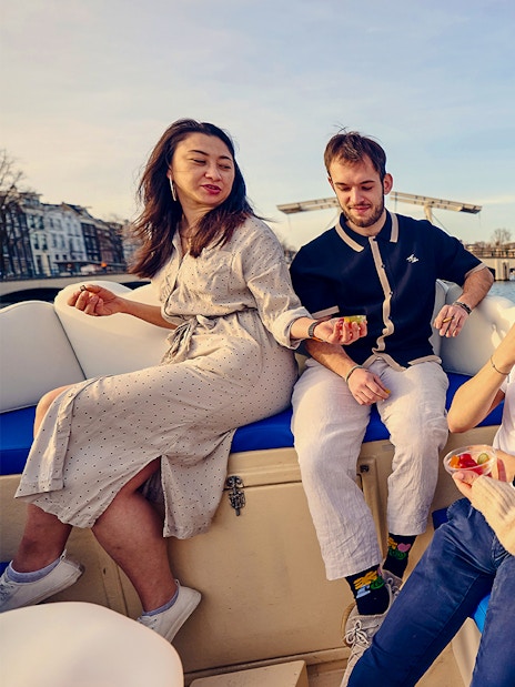 Guests enjoying snacks on the Cloud Boat Cruise in Amsterdam canals.