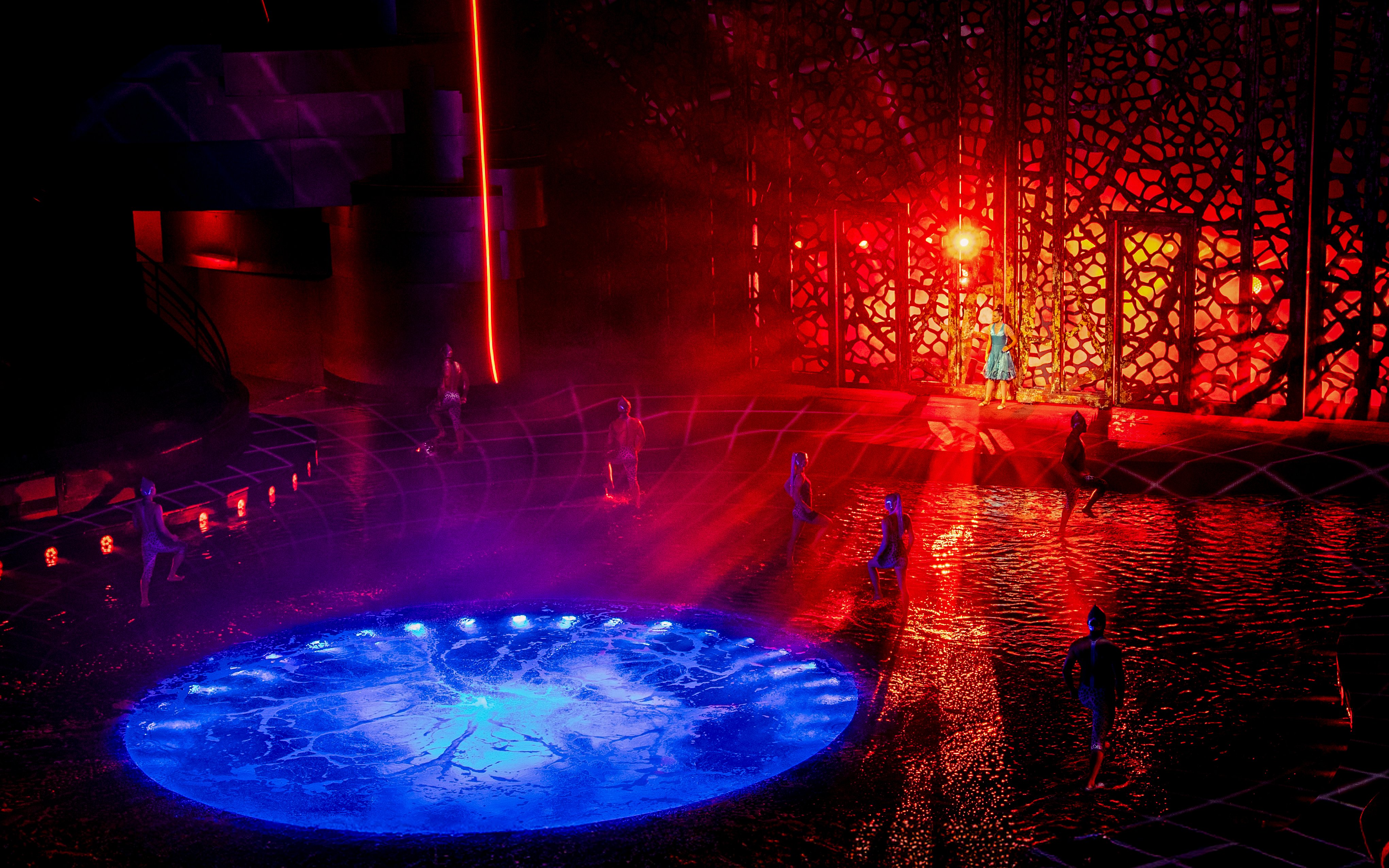 Performers on stage with water effects during La Perle show, Red Sea theme.