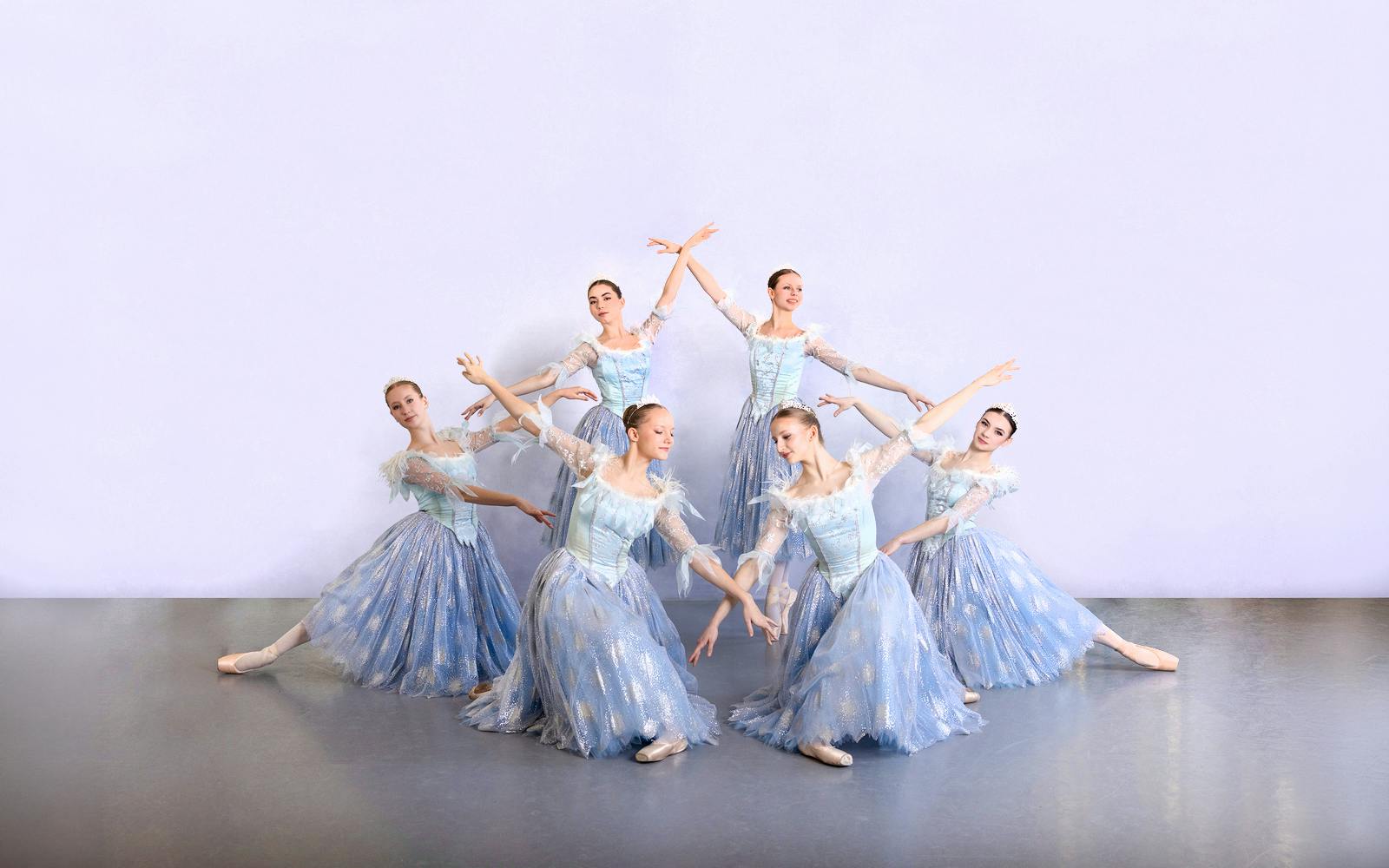 Ballet dancers in blue costumes performing at a gala in Prague's Old Town.