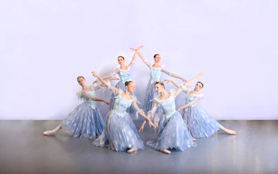 Ballet dancers in blue costumes performing at a gala in Prague's Old Town.