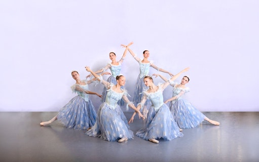 Ballet dancers in blue costumes performing at a gala in Prague's Old Town.