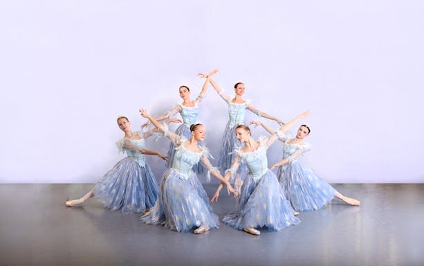 Ballet dancers in blue costumes performing at a gala in Prague's Old Town.