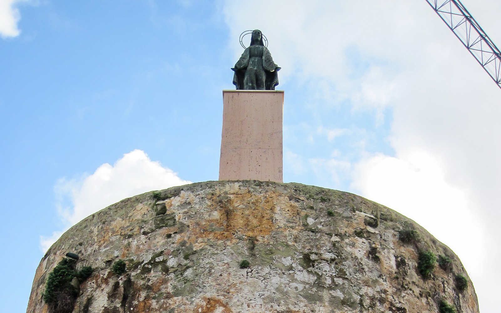 Statue atop ancient tower in Alghero historic center.