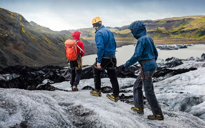 Hikers trekking on Solheimajökill Glacier in Iceland.