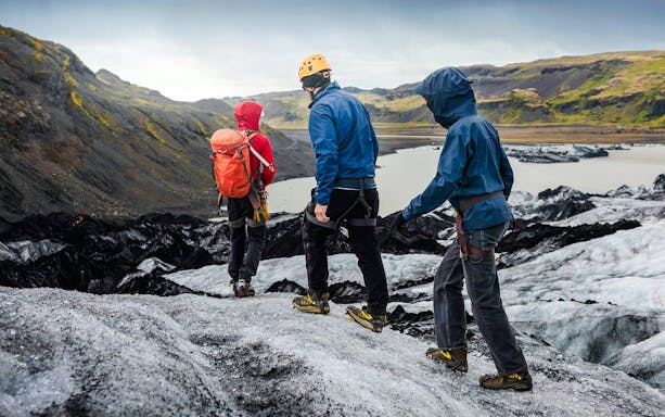 Hikers trekking on Solheimajökill Glacier in Iceland.