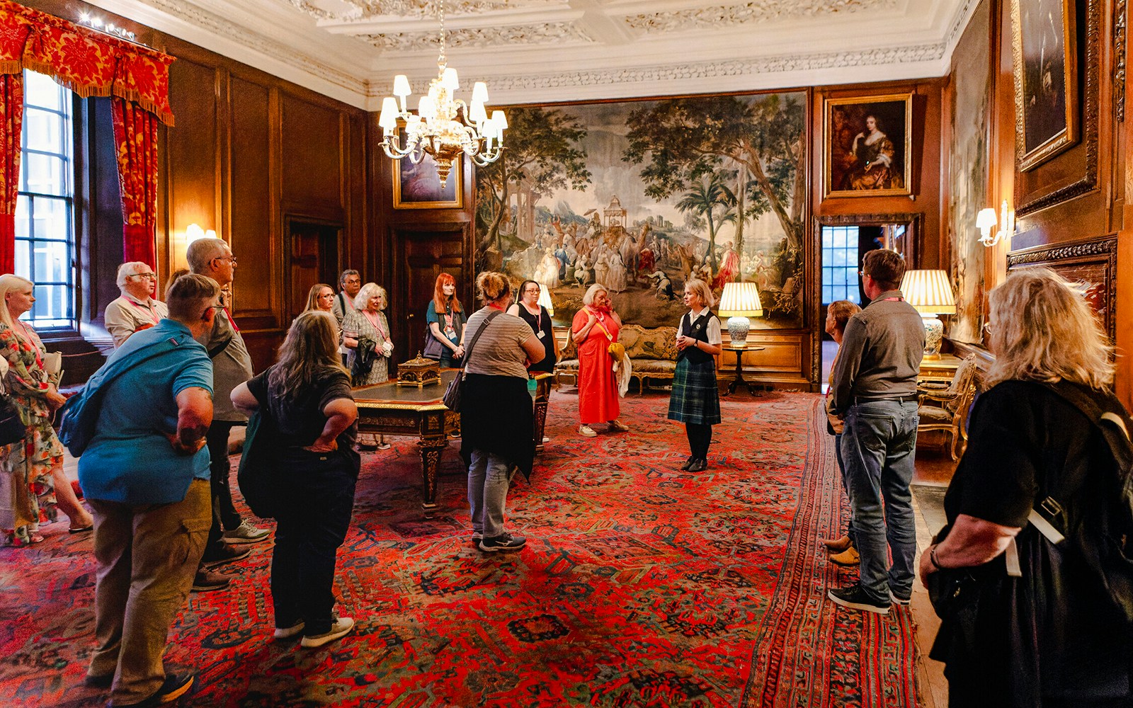 Guided group tour inside the ornate room of Palace of Holyroodhouse, Edinburgh.