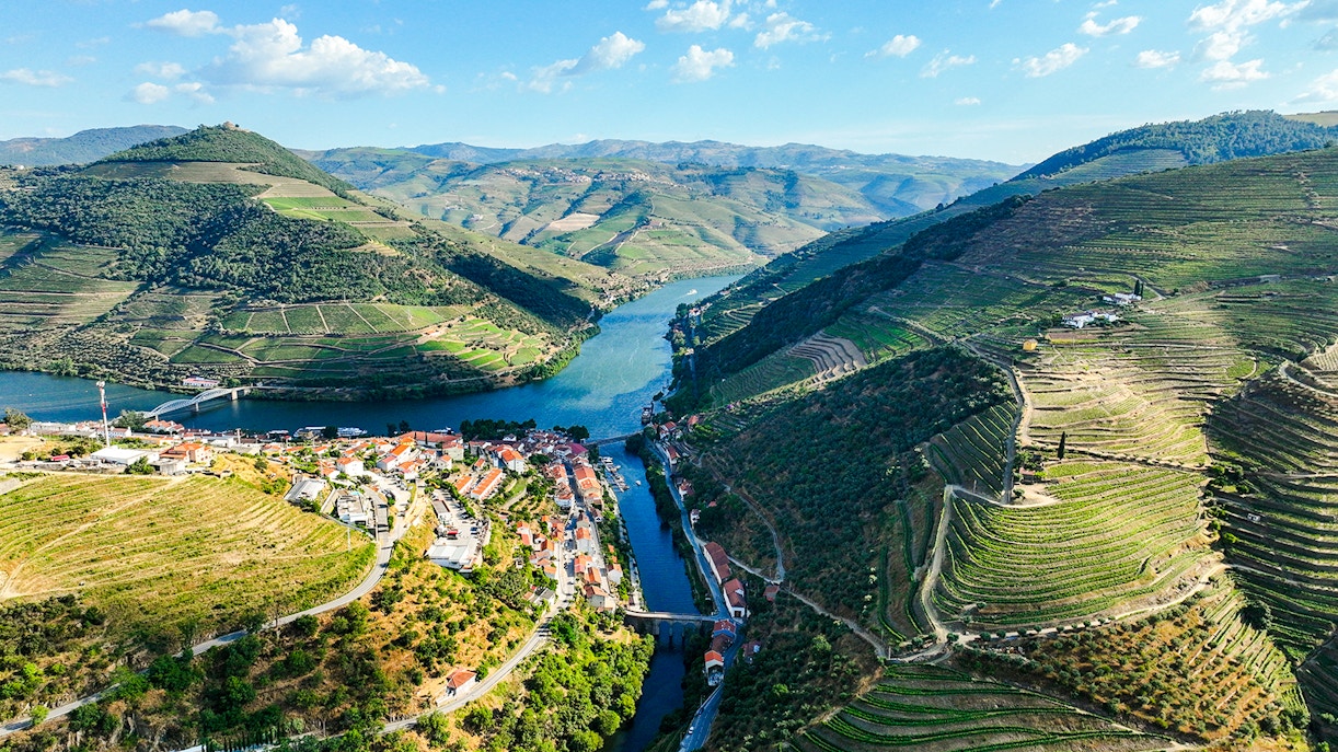 Aerial view of Pinhão village by Tua River with terraced vineyards in Portugal.