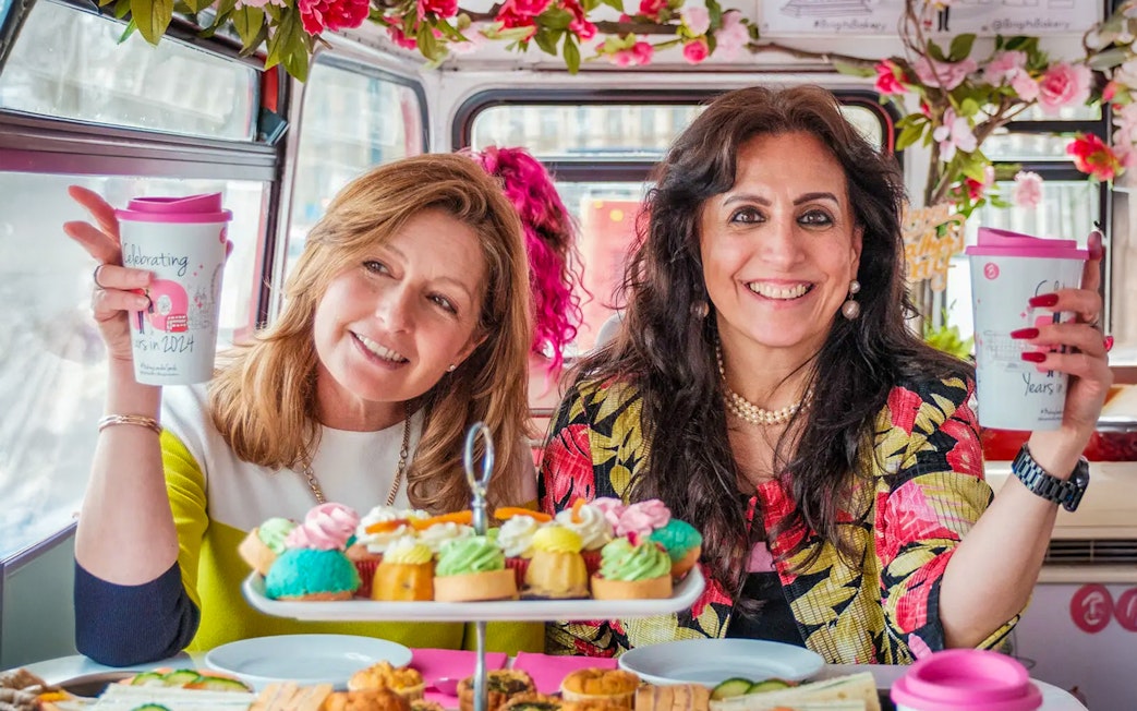 Guests enjoying pastries and drinks on the Classic Afternoon Tea Bus Tour.