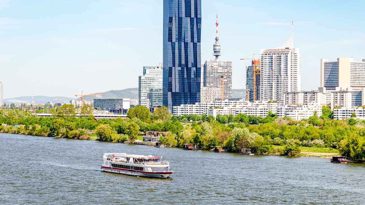 Vienna cityscape with Danube River and modern buildings.
