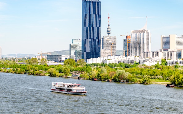 Vienna cityscape with Danube River and modern buildings.