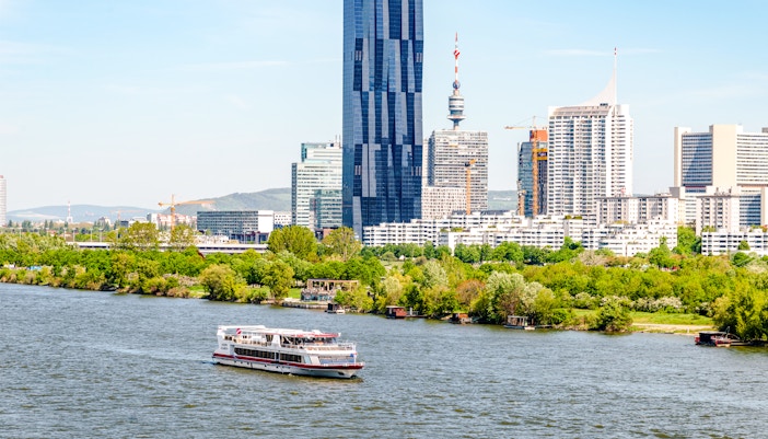 Vienna cityscape with Danube River and modern buildings.