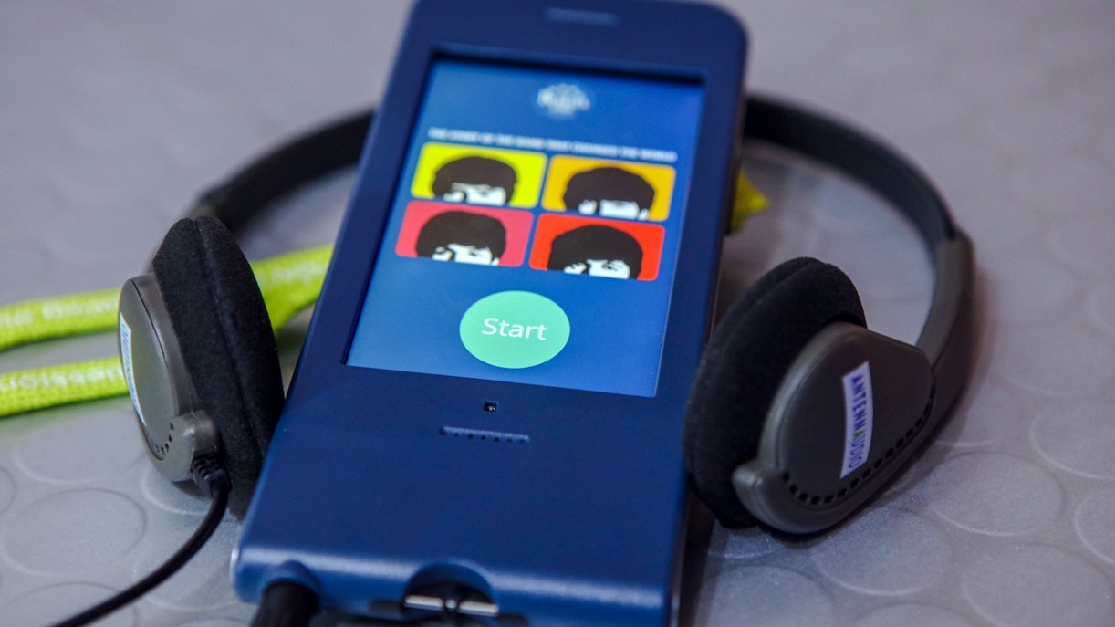 Audio guide device for The Beatles Story tour with headphones.