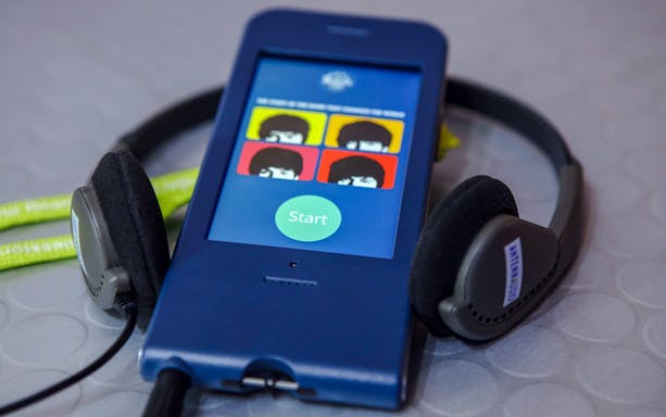 Audio guide device for The Beatles Story tour with headphones.