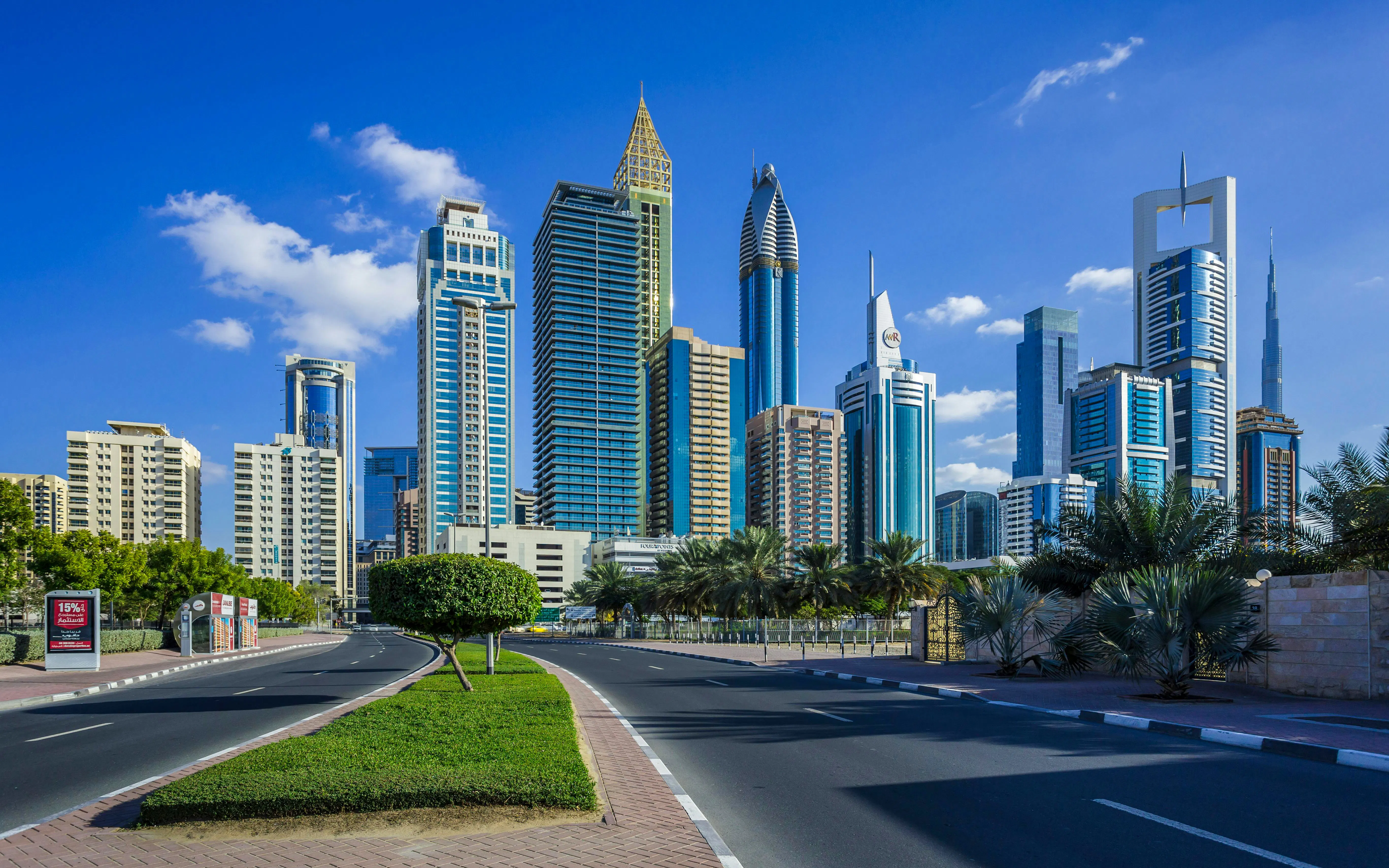 Skyscrapers in Dubai's financial center with clear blue sky.
