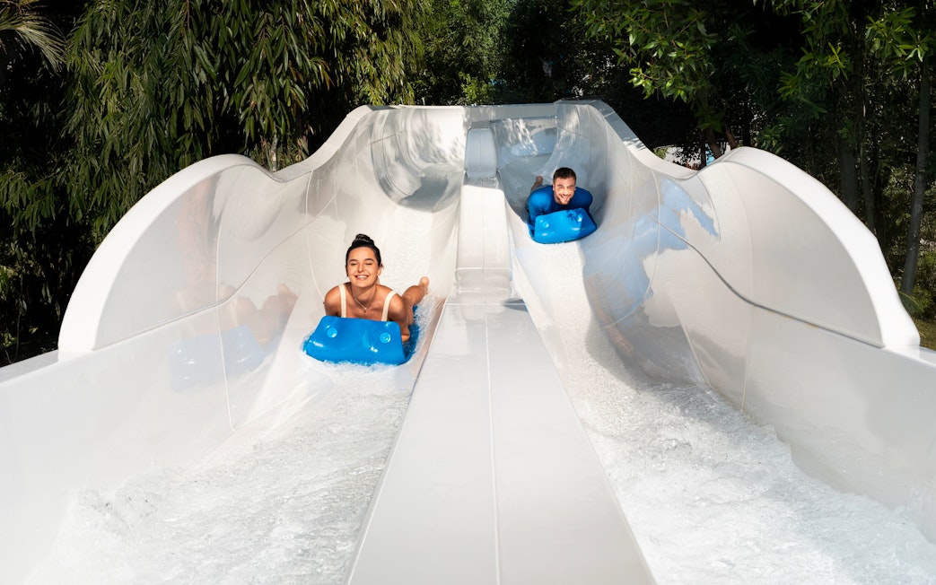 People tubing down water slide at Grand Hyatt waterpark, Dubai.