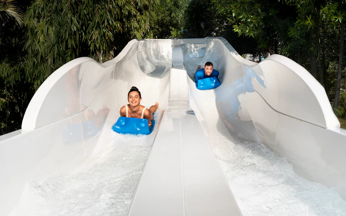 People tubing down water slide at Grand Hyatt waterpark, Dubai.