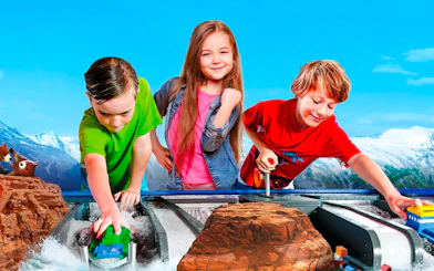 Children playing with LEGO boats at LEGOLAND Billund water ride.