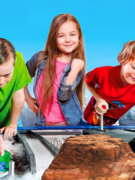 Children playing with LEGO boats at LEGOLAND Billund water ride.