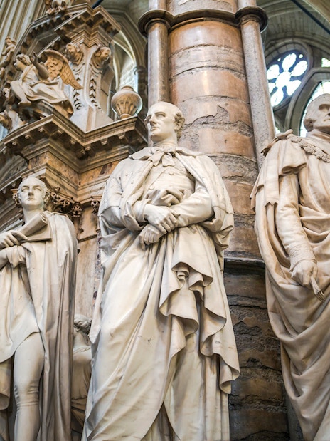Statues inside Westminster Abbey, London, showcasing historical figures.