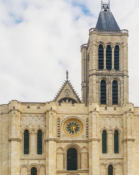 Basilica of Saint Denis facade with rose window and tower in Paris.