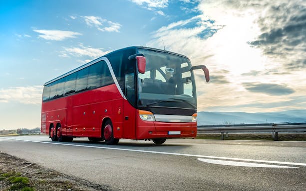 Red tour bus on highway en route to Krka National Park from Zadar.
