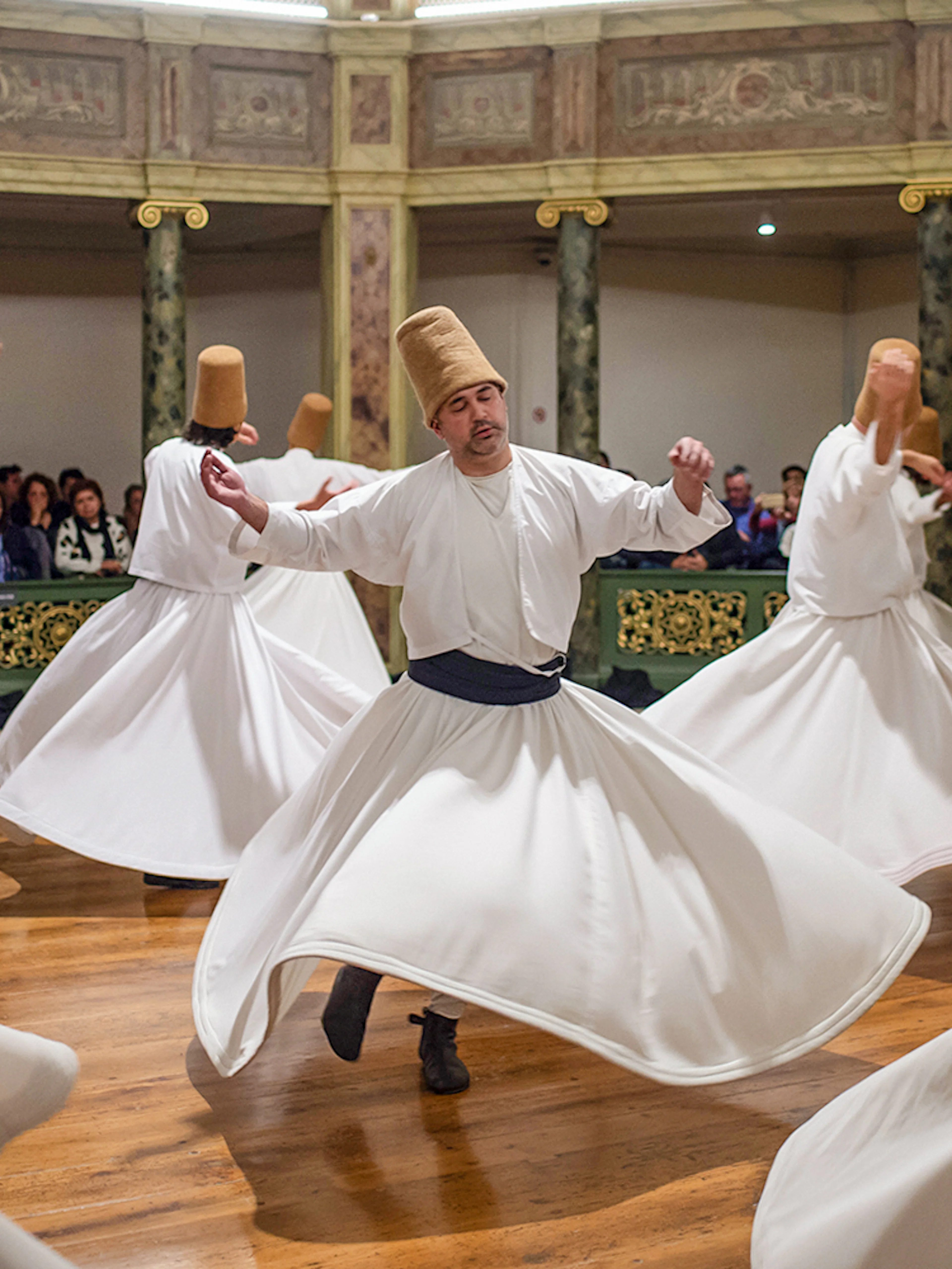 Whirling dervishes performing in a traditional ceremony in Cappadocia, Turkey.