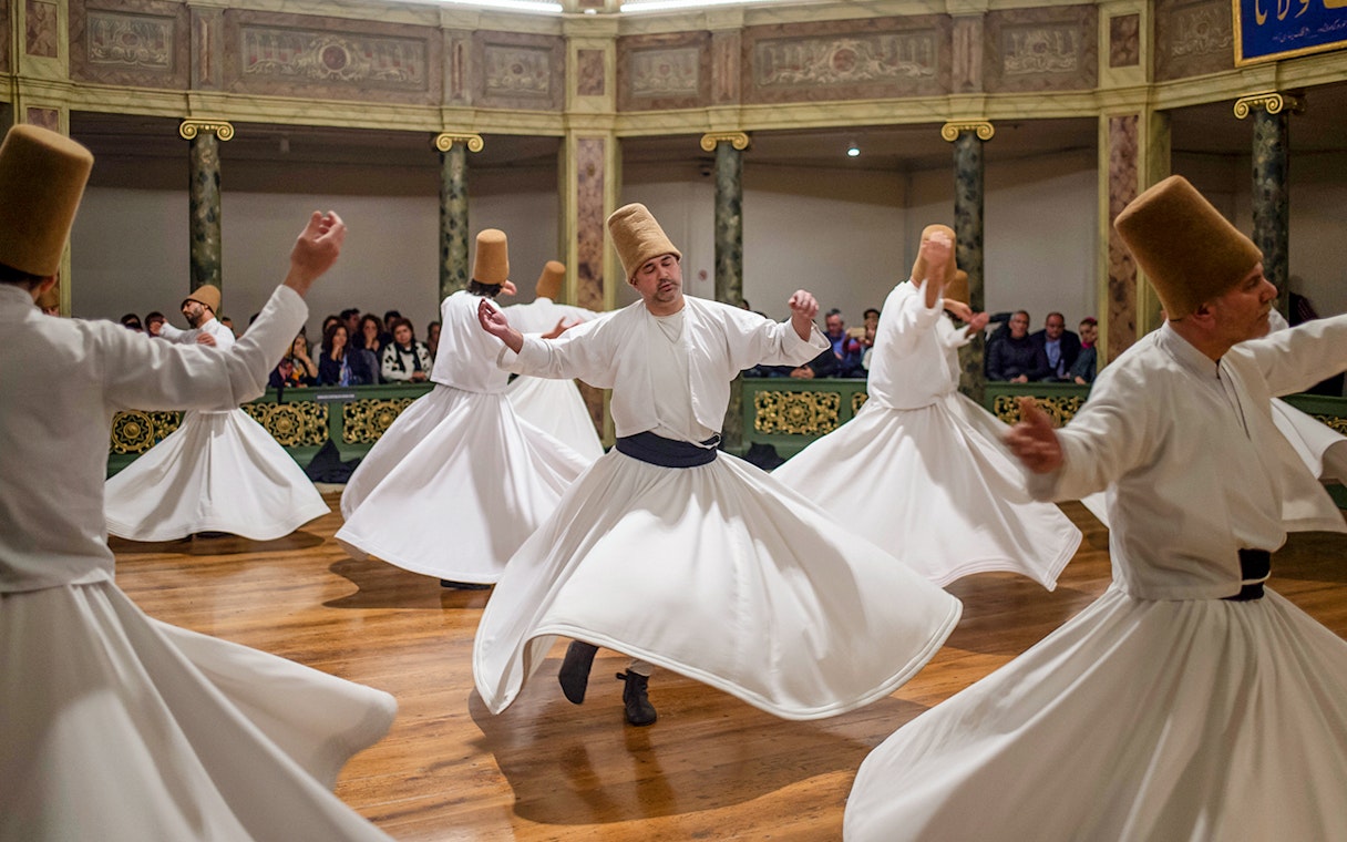 Whirling dervishes performing in a traditional ceremony in Cappadocia, Turkey.