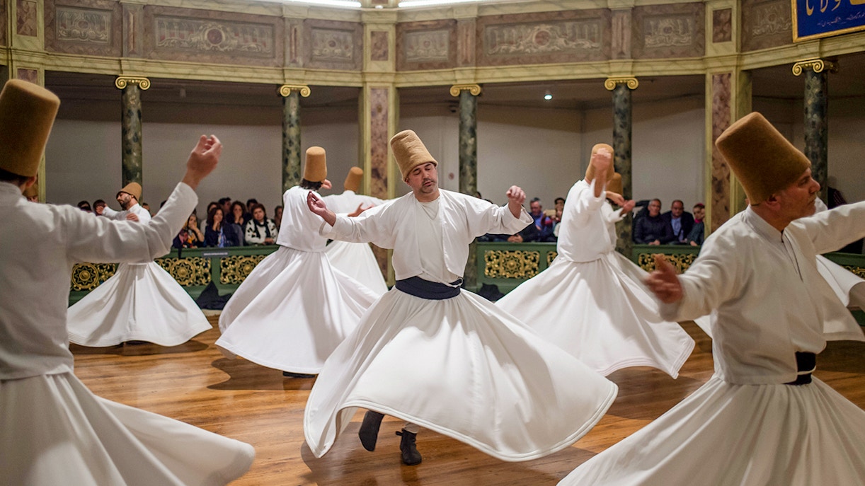 Whirling dervishes performing in a traditional ceremony in Cappadocia, Turkey.