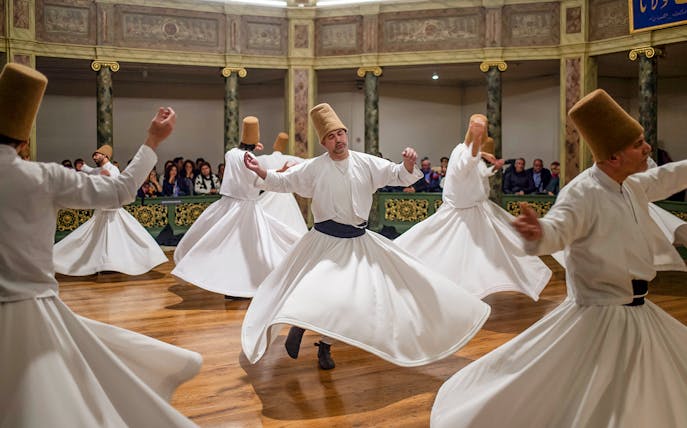 Whirling dervishes performing in a traditional ceremony in Cappadocia, Turkey.