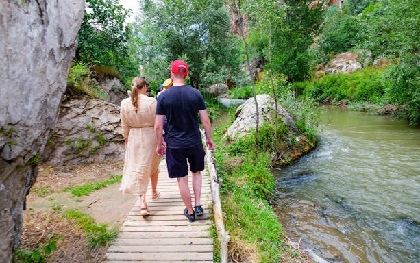 Family walking along a riverside path in Antalya during a rafting tour.