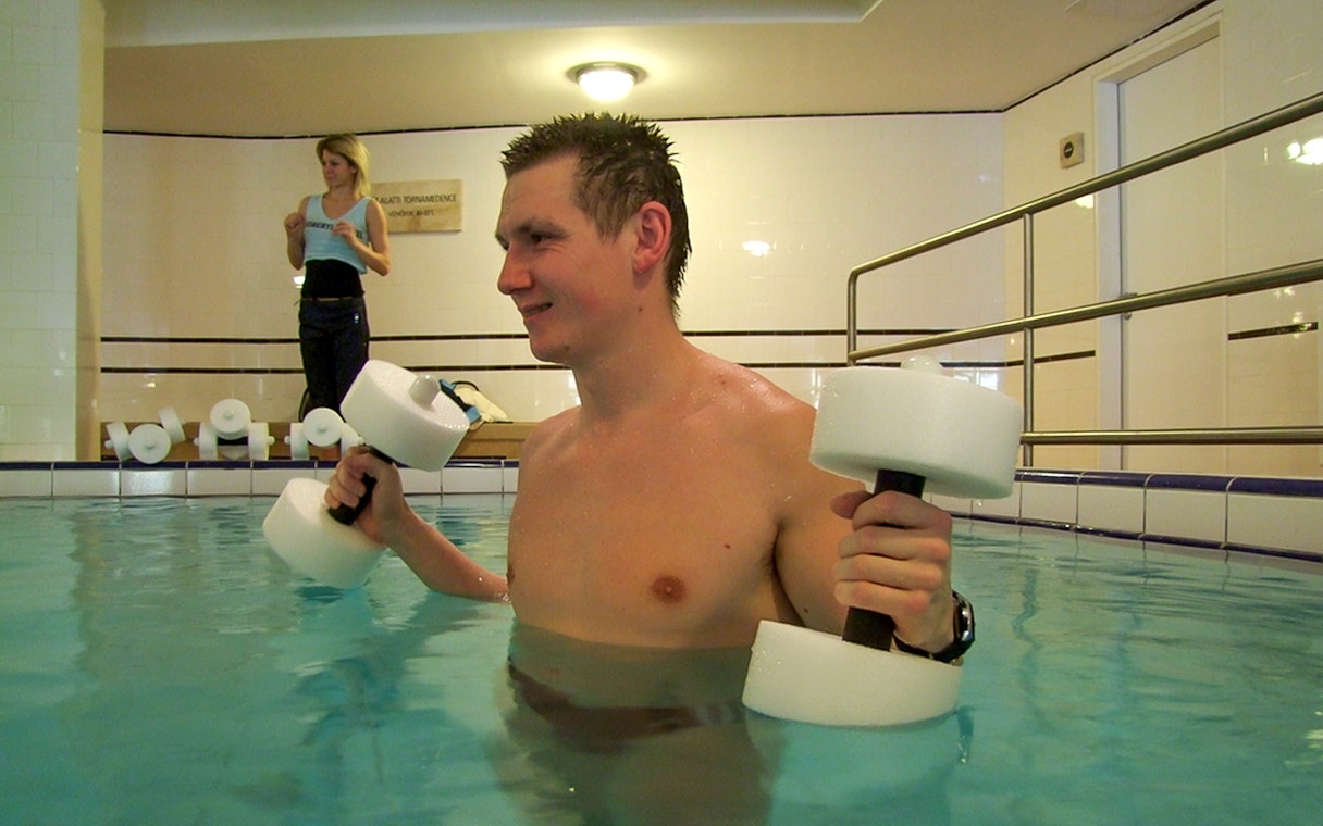 Guests participating in water exercises at Lukacs Spa pool.