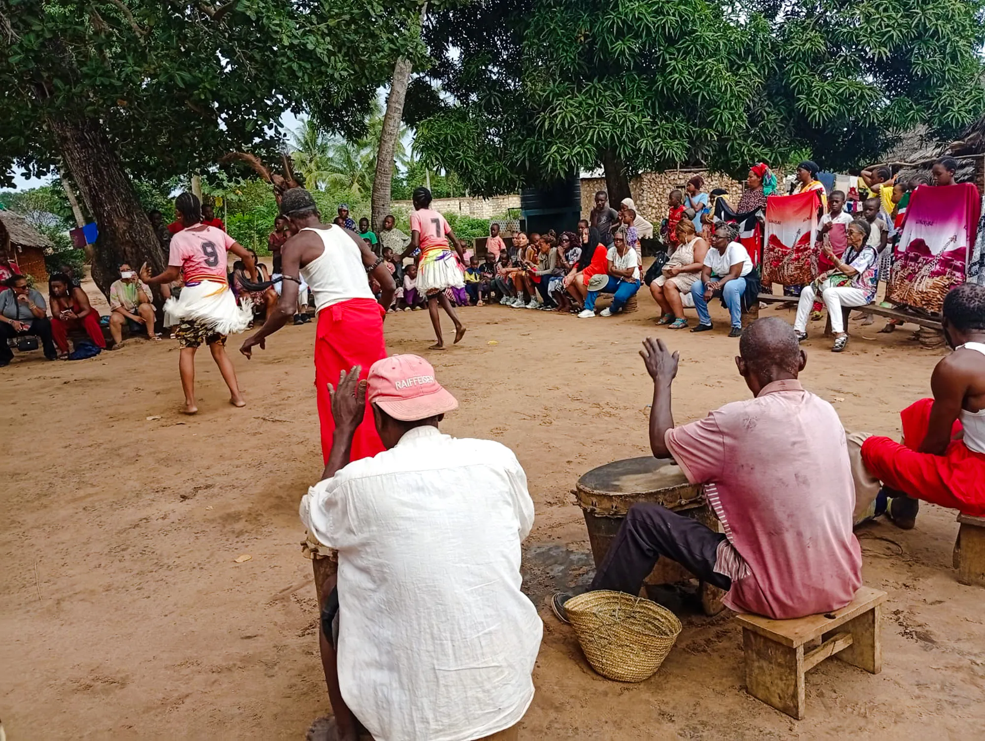 Giriama dancers performing with drummers in a local village, Diani Beach.
