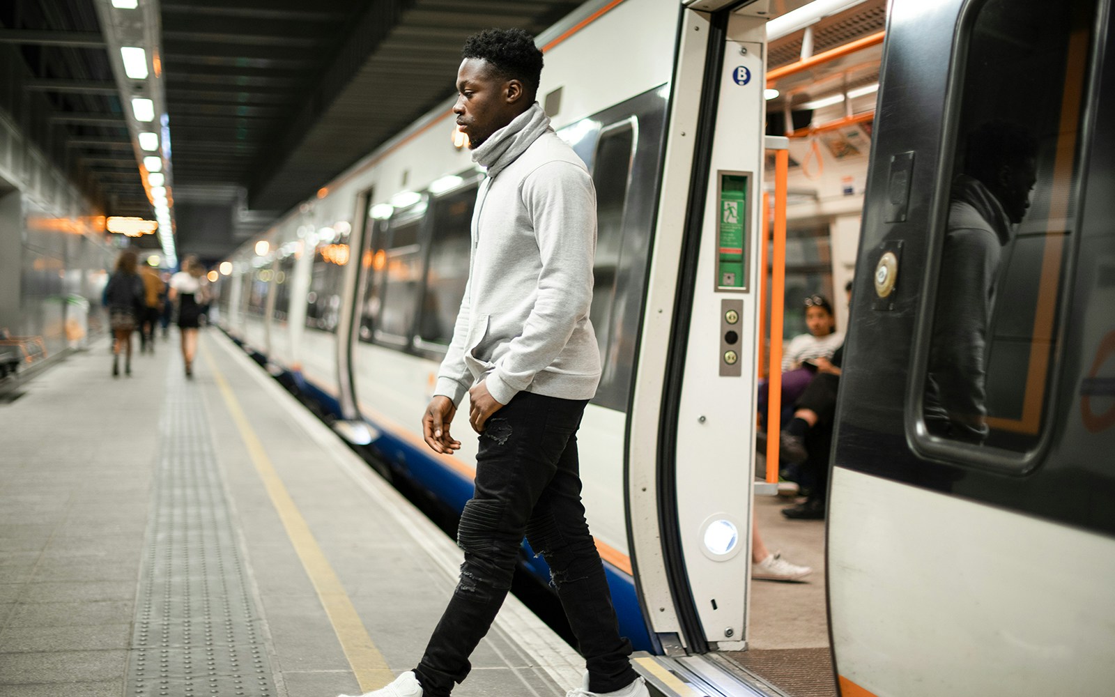 Metro passenger exiting train at station