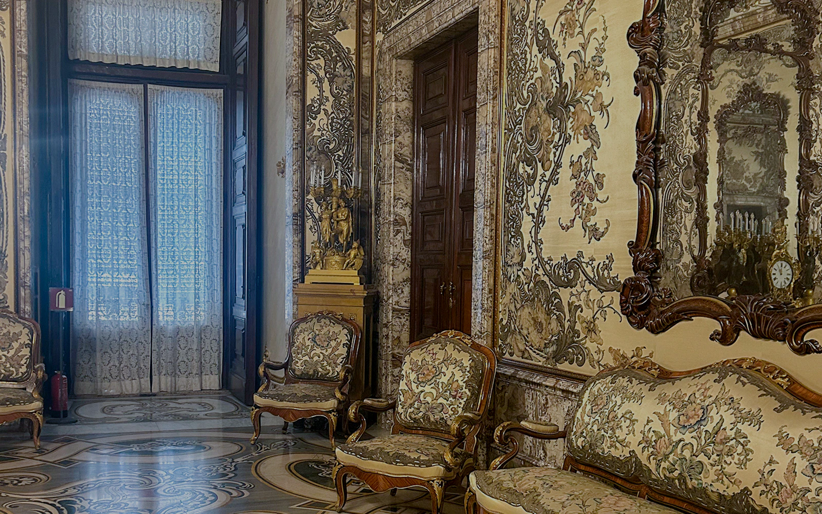 Gasparini's Hall interior with ornate furniture and detailed wall designs, Royal Palace Madrid.