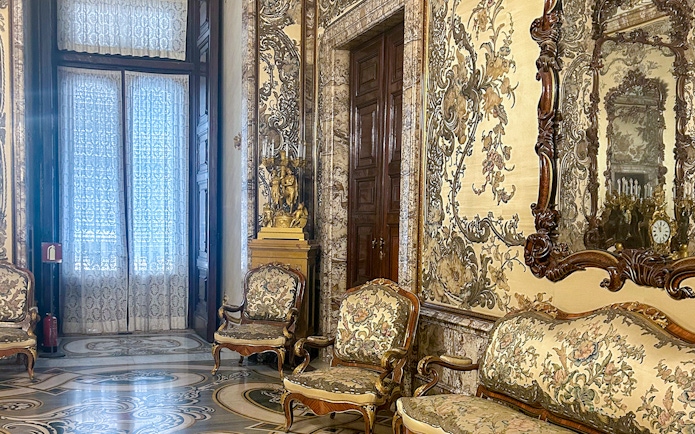 Gasparini's Hall interior with ornate furniture and detailed wall designs, Royal Palace Madrid.